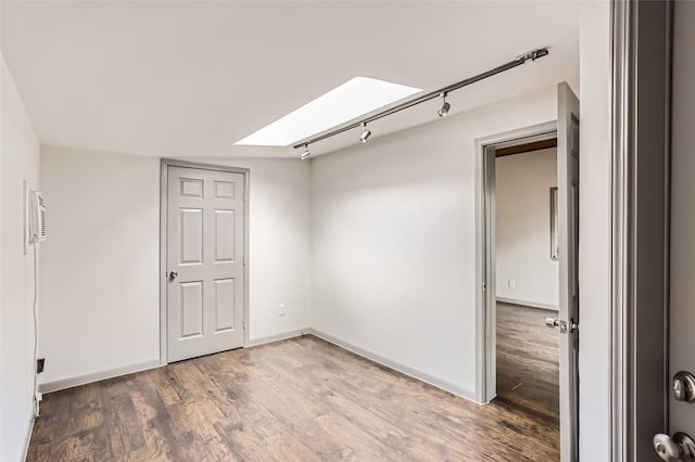 6509 Birdwood Rd, Houston, TX 77074 - spare room featuring a skylight, wood finished floors, baseboards, and rail lighting
