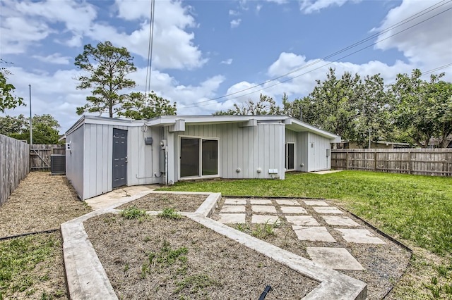 6509 Birdwood Rd, Houston, TX 77074 - back of house featuring board and batten siding and central air condition unit