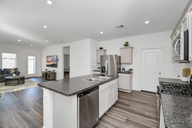 5227 Castlebury Meadows Dr, Spring, TX 77373 - kitchen featuring appliances with stainless steel finishes, a sink, open floor plan, dark wood-style flooring, and recessed lighting