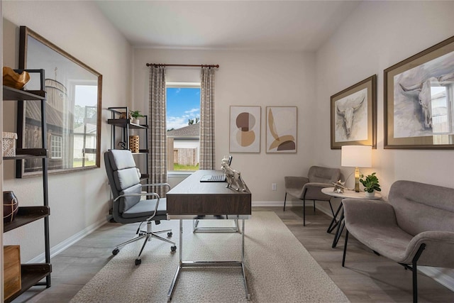 12235 Danza Dr, Willis, TX 77318 - office area featuring wood finished floors and baseboards