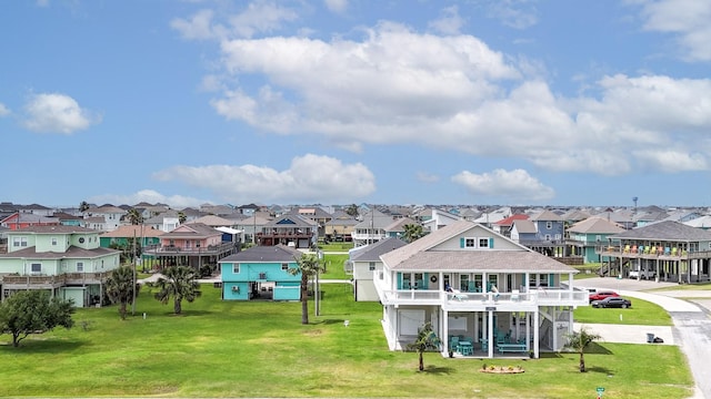 985 Sue Dr, Crystal Beach, TX 77650 - rear view of house with a residential view and a lawn