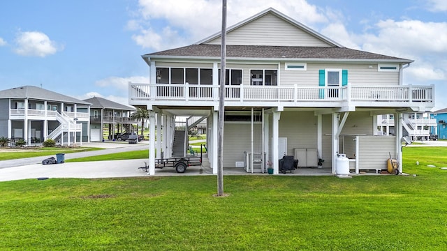 985 Sue Dr, Crystal Beach, TX 77650 - back of house featuring a shingled roof, a yard, stairs, and a sunroom