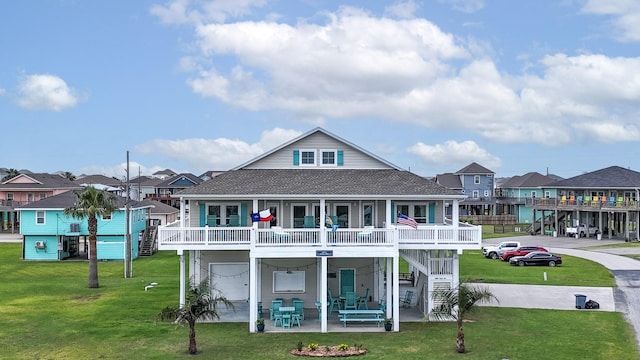985 Sue Dr, Crystal Beach, TX 77650 - back of property with a residential view, roof with shingles, a patio, a lawn, and stairs