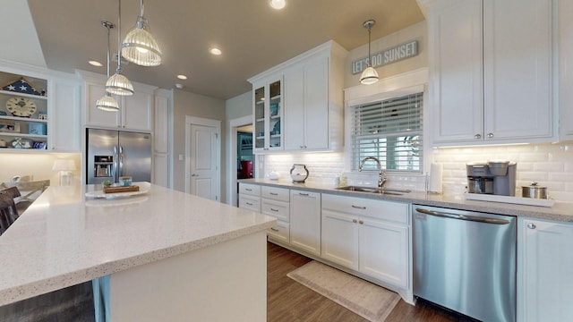 985 Sue Dr, Crystal Beach, TX 77650 - kitchen with appliances with stainless steel finishes, a sink, white cabinets, recessed lighting, and decorative backsplash