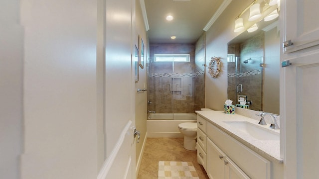 985 Sue Dr, Crystal Beach, TX 77650 - bathroom featuring vanity, toilet, tile patterned flooring, ornamental molding, and shower / bath combination with glass door