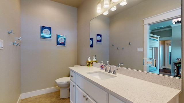 985 Sue Dr, Crystal Beach, TX 77650 - bathroom featuring toilet, vanity, baseboards, and tile patterned floors