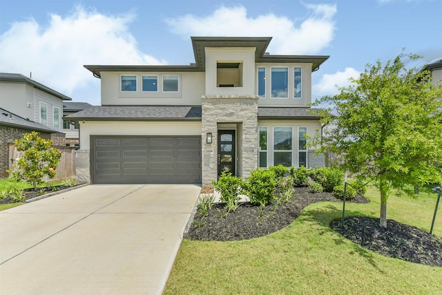 21606 Laggan Cliff Ln, Cypress, TX 77433 - view of front of home with stucco siding, an attached garage, driveway, a front yard, and stone siding