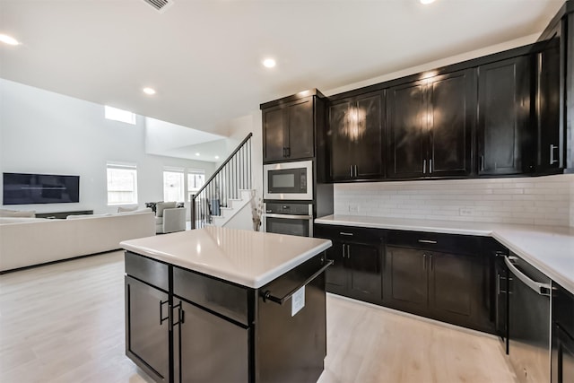 21606 Laggan Cliff Ln, Cypress, TX 77433 - kitchen featuring stainless steel appliances, light wood-style flooring, backsplash, and recessed lighting