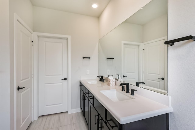 21606 Laggan Cliff Ln, Cypress, TX 77433 - bathroom with double vanity and baseboards