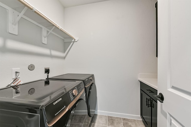 21606 Laggan Cliff Ln, Cypress, TX 77433 - laundry area with washer and clothes dryer, baseboards, cabinet space, and light tile patterned floors