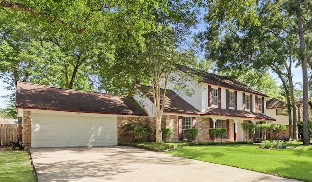 5310 Brownlee Ln, Spring, TX 77379 - view of front facade with concrete driveway, an attached garage, and brick siding