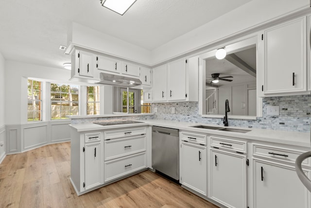 5310 Brownlee Ln, Spring, TX 77379 - kitchen featuring a sink, stainless steel dishwasher, light countertops, backsplash, and white cabinets