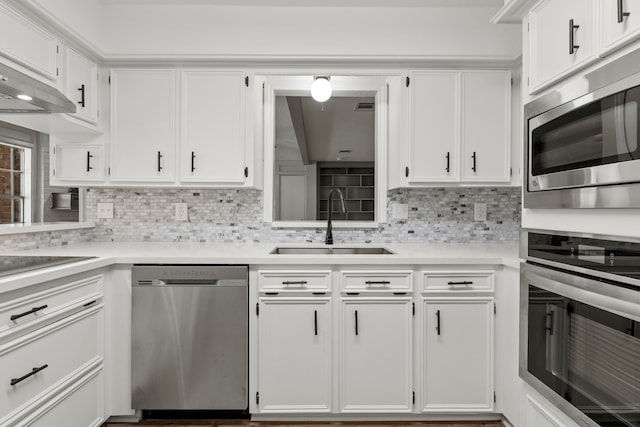 5310 Brownlee Ln, Spring, TX 77379 - kitchen with appliances with stainless steel finishes, a sink, light countertops, white cabinets, and backsplash