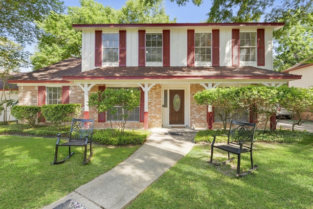 5310 Brownlee Ln, Spring, TX 77379 - view of front of home with brick siding, a front yard, and a porch