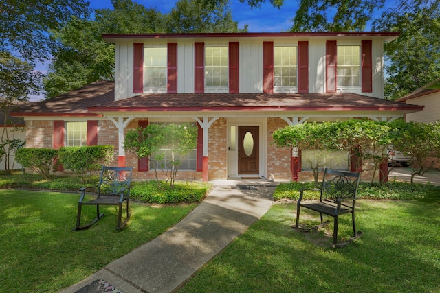 5310 Brownlee Ln, Spring, TX 77379 - view of front of home with a front yard, a porch, and brick siding