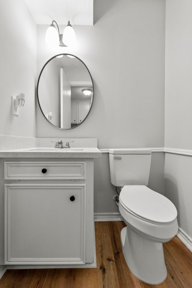 5310 Brownlee Ln, Spring, TX 77379 - half bath featuring baseboards, vanity, wood finished floors, and toilet