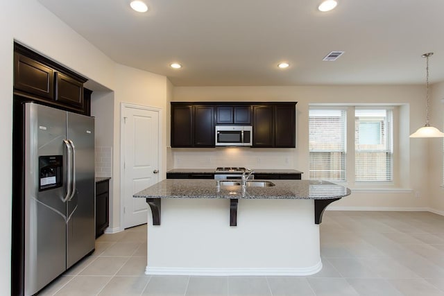 1626 Summer City Dr, Houston, TX 77047 - kitchen featuring appliances with stainless steel finishes, a sink, stone countertops, backsplash, and recessed lighting
