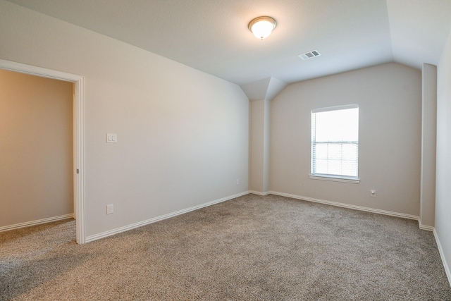 209 Cambria Green Ln, Katy, TX 77493 - spare room featuring carpet flooring, lofted ceiling, and baseboards