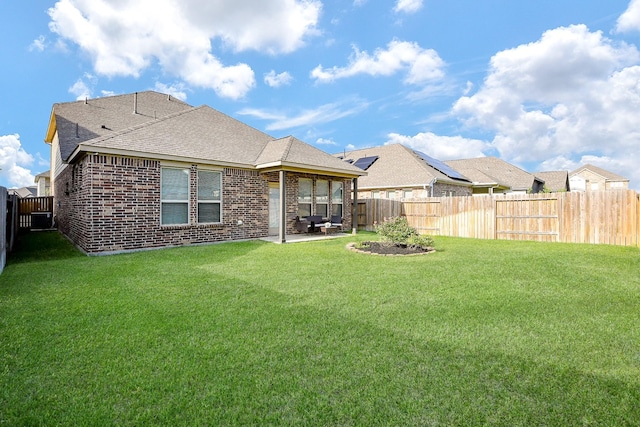209 Cambria Green Ln, Katy, TX 77493 - rear view of house with brick siding, a patio area, roof with shingles, and central air condition unit