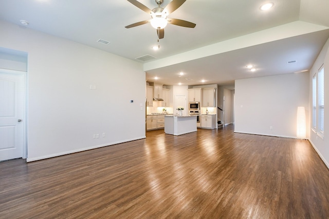 209 Cambria Green Ln, Katy, TX 77493 - unfurnished living room with dark wood-style flooring, ceiling fan, baseboards, and recessed lighting