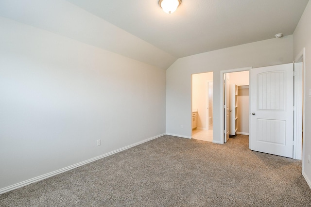 209 Cambria Green Ln, Katy, TX 77493 - unfurnished bedroom with carpet flooring, baseboards, lofted ceiling, and ensuite bath