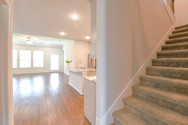 209 Cambria Green Ln, Katy, TX 77493 - stairway featuring wood finished floors, a ceiling fan, recessed lighting, and baseboards