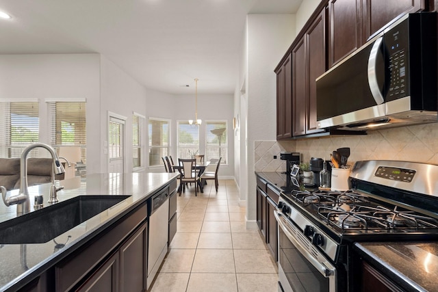 17222 Fable Springs Ln, Cypress, TX 77433 - kitchen featuring stainless steel appliances, a sink, decorative backsplash, dark stone countertops, and recessed lighting