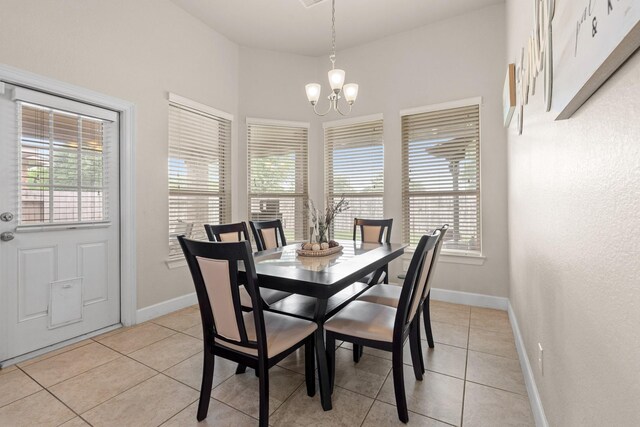 17222 Fable Springs Ln, Cypress, TX 77433 - dining room with a chandelier, light tile patterned flooring, and baseboards