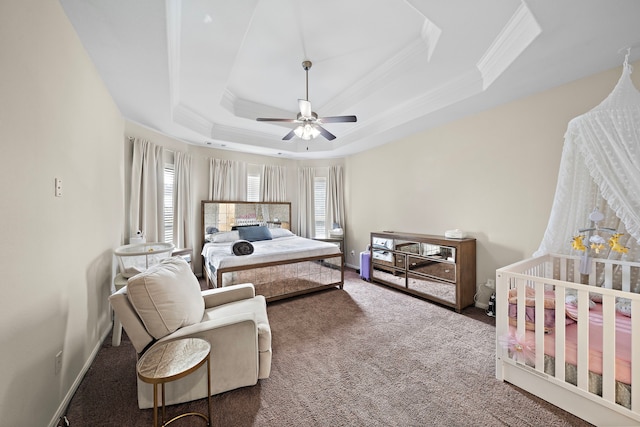 3627 Grand Promenade Ln, Stafford, TX 77477 - carpeted bedroom with ornamental molding, multiple windows, a tray ceiling, baseboards, and a ceiling fan