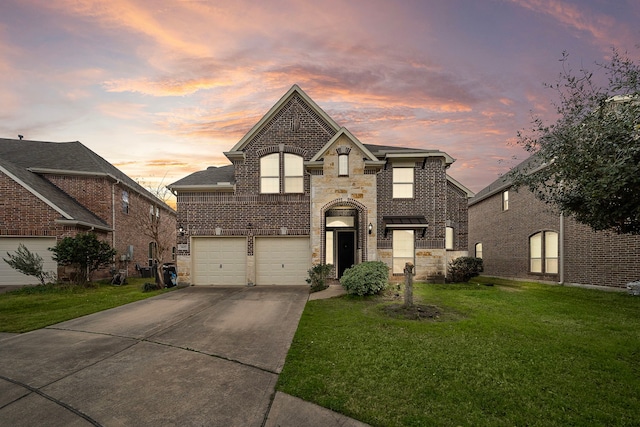 3627 Grand Promenade Ln, Stafford, TX 77477 - french country inspired facade featuring a yard, a garage, concrete driveway, and brick siding