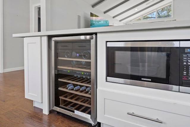 3531 Westridge St, Houston, TX 77025 - bar area featuring beverage cooler, stainless steel microwave, dark wood finished floors, vaulted ceiling, and baseboards