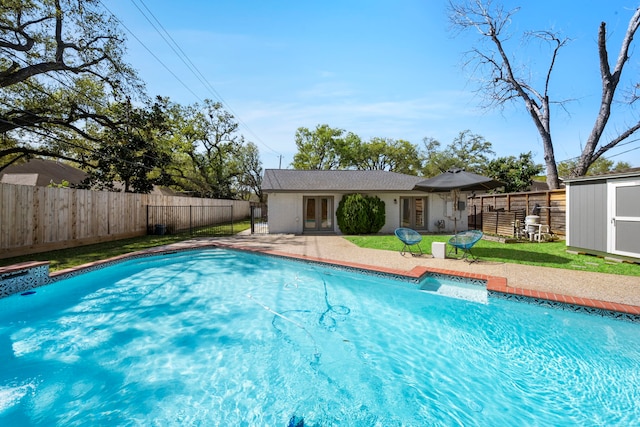 3531 Westridge St, Houston, TX 77025 - view of pool with french doors, a patio area, a fenced backyard, an outbuilding, and a shed