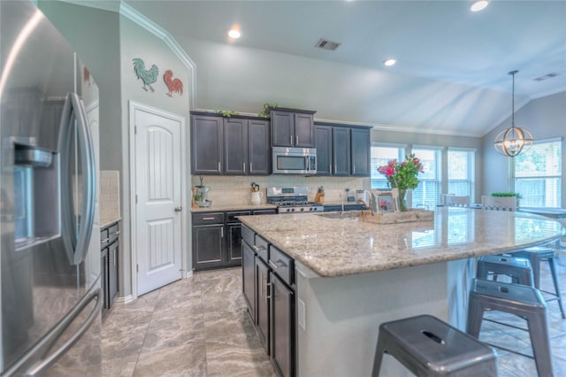 2255 Golden Laurel Dr, Conroe, TX 77304 - kitchen with stainless steel appliances, lofted ceiling, a breakfast bar area, ornamental molding, and decorative backsplash