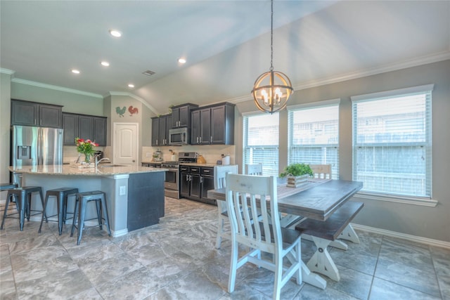 2255 Golden Laurel Dr, Conroe, TX 77304 - kitchen featuring stainless steel appliances, a chandelier, decorative backsplash, crown molding, and light stone countertops