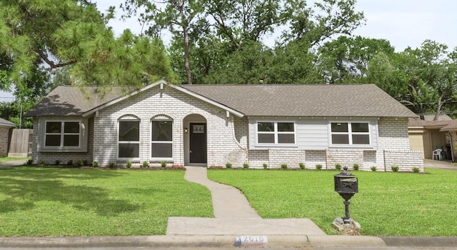 2610 Moss Hill Dr, Houston, TX 77080 - single story home featuring a front yard, roof with shingles, and brick siding
