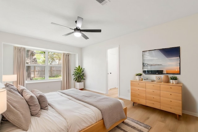 2610 Moss Hill Dr, Houston, TX 77080 - bedroom featuring light wood-style floors, baseboards, and a ceiling fan