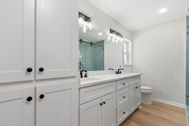 2610 Moss Hill Dr, Houston, TX 77080 - full bath with a stall shower, wood finished floors, double vanity, toilet, and baseboards