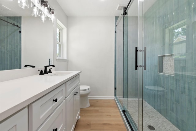 2610 Moss Hill Dr, Houston, TX 77080 - full bath featuring toilet, a shower stall, vanity, and wood finished floors