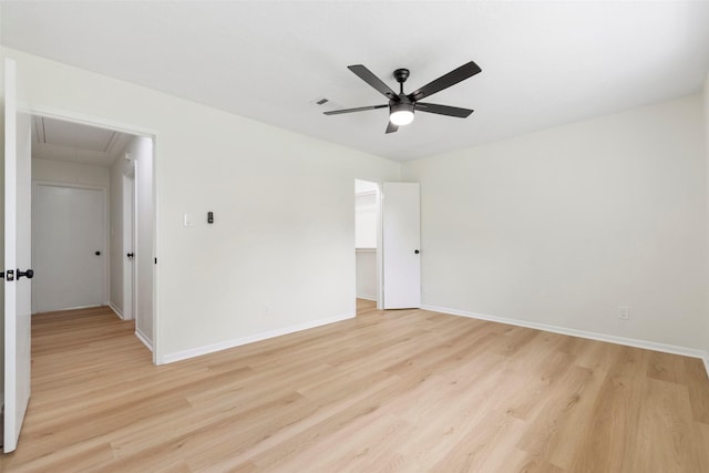 2610 Moss Hill Dr, Houston, TX 77080 - spare room featuring attic access, light wood-style floors, a ceiling fan, and baseboards