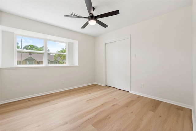 2610 Moss Hill Dr, Houston, TX 77080 - unfurnished bedroom featuring wood finished floors, baseboards, a closet, and a ceiling fan