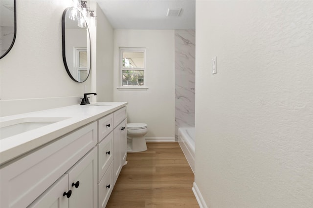 2610 Moss Hill Dr, Houston, TX 77080 - bathroom featuring wood finished floors, double vanity, toilet, a shower, and a bath