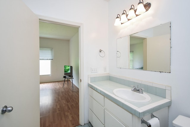 117 E 25th St, Houston, TX 77008 - bathroom featuring vanity, wood finished floors, and toilet