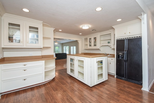 117 E 25th St, Houston, TX 77008 - kitchen featuring open shelves, black fridge, wood counters, white cabinetry, and dark wood finished floors