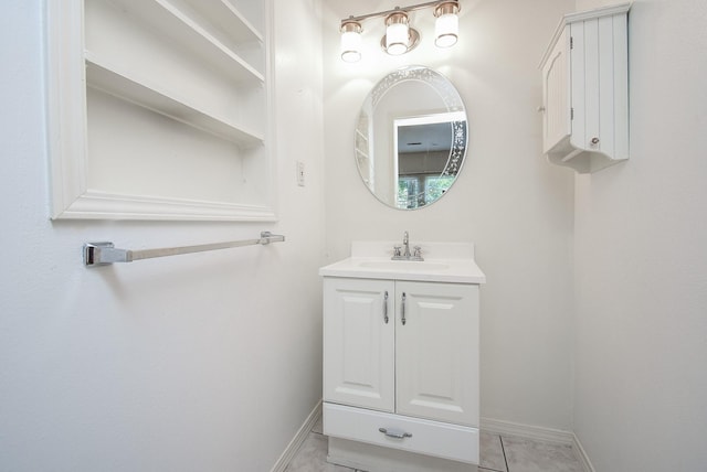 117 E 25th St, Houston, TX 77008 - bathroom featuring vanity, baseboards, and tile patterned flooring