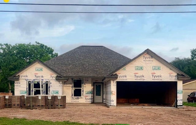 52 Leeder Ct, Lake Jackson, TX 77566 - unfinished property featuring a garage, driveway, and roof with shingles