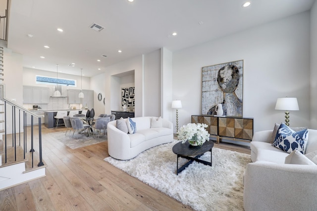 2105 Emancipation Ave, Houston, TX 77003 - living area with light wood-type flooring, stairs, and recessed lighting