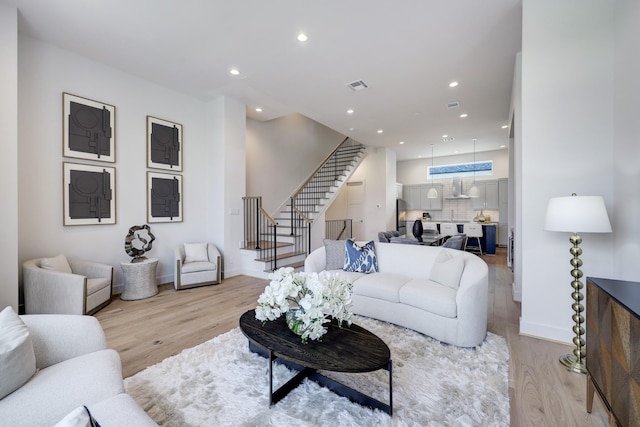2105 Emancipation Ave, Houston, TX 77003 - living area with stairs, light wood finished floors, recessed lighting, and baseboards