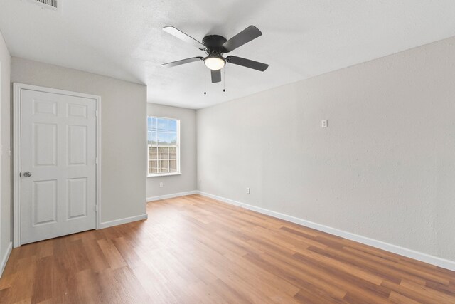 3221 Hage St, Houston, TX 77093 - unfurnished bedroom with light wood finished floors, baseboards, and a ceiling fan
