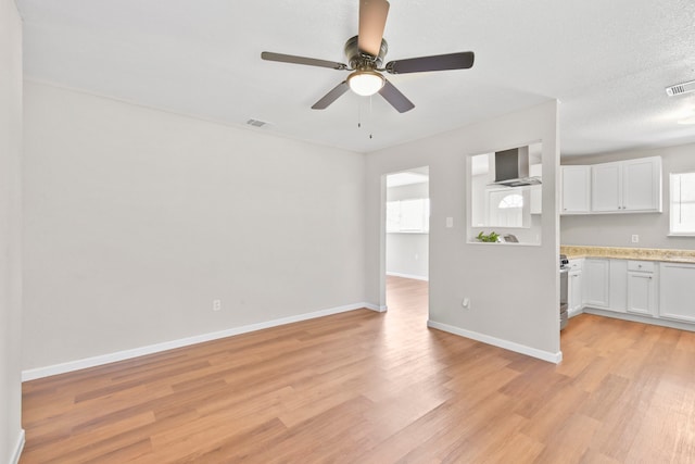 3221 Hage St, Houston, TX 77093 - unfurnished living room featuring light wood-style flooring, a ceiling fan, and baseboards