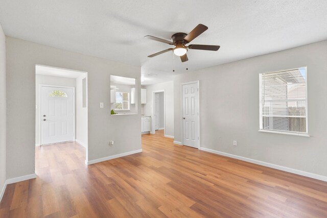 3221 Hage St, Houston, TX 77093 - spare room featuring light wood finished floors, a ceiling fan, and baseboards